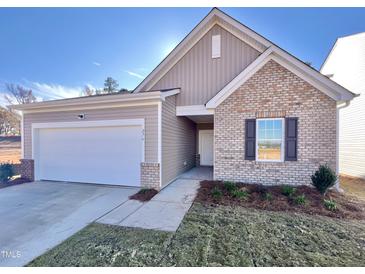 Brick and siding exterior of charming craftsman style home at 276 Babbling Brook Dr, Clayton, NC 27520