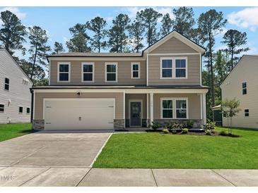 Charming two-story home featuring a two-car garage and well-manicured lawn at 1216 Dimaggio Dr # 29, Raleigh, NC 27616