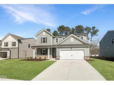 Two-story home featuring a two-car garage, manicured lawn, and neutral siding at 1221 Dimaggio Dr # 10, Raleigh, NC 27616