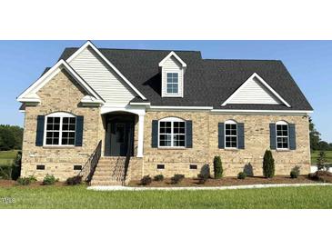 Charming brick home with black shutters, and beautifully landscaped front yard on a sunny day at 1665 S Old Carriage Rd, Rocky Mount, NC 27804