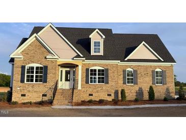 Charming brick home with a combination of siding and a well manicured yard at 1665 S Old Carriage Rd, Rocky Mount, NC 27804