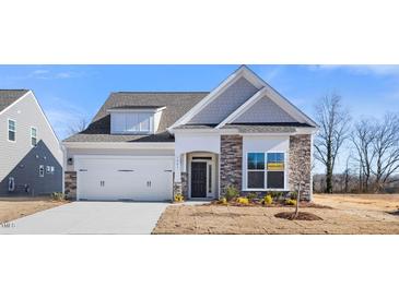 Two-story house with stone accents and a two-car garage at 1221 Cricket St, Elon, NC 27244