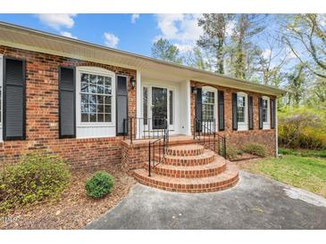 Brick ranch house with a welcoming front entrance and steps at 1355 Shamrock Dr, Burlington, NC 27215