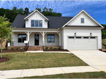 Charming new construction home with a two-car garage, landscaped front yard, and inviting front porch at 6040 Scalybark Road, Durham, NC 27712