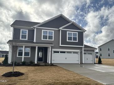Beautiful two-story home featuring gray siding and a three-car garage at 88 Bering Cir, Angier, NC 27501