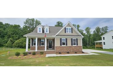 Charming single-Gathering home with tan siding, brick foundation, and a cozy front porch at 294 White Azalea Way, Homesite 74, Benson, NC 27504
