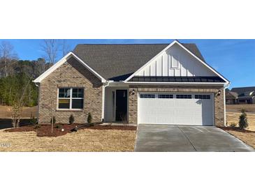 Charming single-story brick home with a two-car garage and well-manicured landscaping at 55 Sawtooth Oak Ln, Youngsville, NC 27596