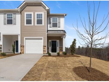 Charming townhome with a one-car garage, neutral siding, and a well-maintained front yard at 53 Lavender Ln, Clayton, NC 27520