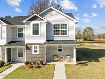 Two-story house with gray siding, covered porch, and landscaping at 918 E Green St # A102, Franklinton, NC 27525