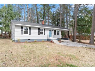 Charming single-story home with a cozy front yard, driveway, and a blue front door at 320 Zollicoffer Ave, Henderson, NC 27536