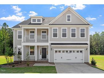 Charming two-story home featuring a covered porch, balcony, and a two-car garage in a desirable neighborhood at 35 Accord Dr, Youngsville, NC 27596