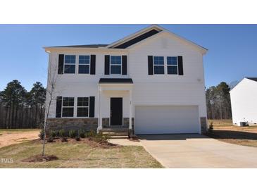Charming two-story home with a well-manicured lawn and attached garage at 55 Calabria Ct, Franklinton, NC 27525