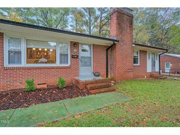 Charming brick home featuring a classic brick chimney and a cozy, inviting entrance at 710 Spring Ln, Sanford, NC 27330