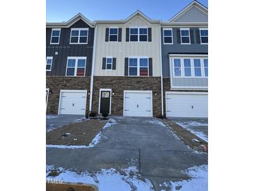 Two-story townhome with attached garage and snow-covered driveway at 855 Parc Townes Dr # 8, Wendell, NC 27591