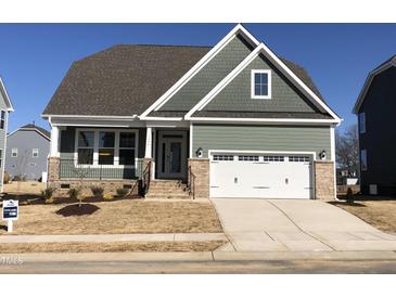 Charming craftsman-style home featuring a two-car garage and inviting front porch at 1600 Maelyn Way, Fuquay Varina, NC 27526