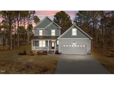 Two-story house with gray siding, a two-car garage, and a front porch at 35 Arbor Dr, Youngsville, NC 27596