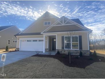 New construction home with attractive light beige exterior and two-car garage at 110 Sawtooth Oak Ln, Youngsville, NC 27596