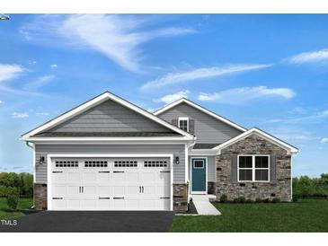 Two-story house with gray siding, stone accents, and a two-car garage at 600 Mathiola Dr, Wendell, NC 27591