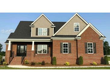 Beautiful brick home featuring a modern design, symmetrical windows and a well-maintained lawn at 7575 Sweetwater Dr, Nashville, NC 27856