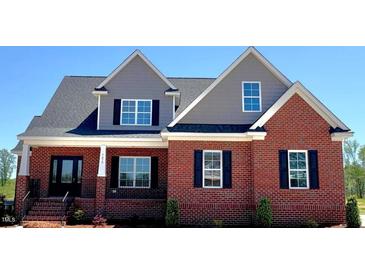 Beautiful new construction home with a brick facade, gray siding, and a well-manicured front yard at 7575 Sweetwater Dr, Nashville, NC 27856