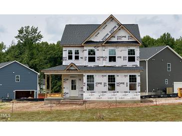 Exterior view of a two-story house with a covered front porch, still under construction at 8816 Melvin St # 15, Willow Springs, NC 27592