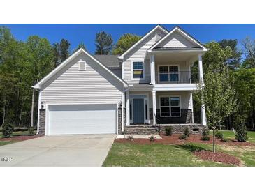 Charming two-story home with a two-car garage, a balcony, and a landscaped yard at 113 Arundel Dr, Archer Lodge, NC 27527