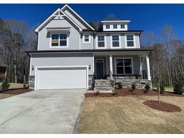 Charming two-story home with a two-car garage and inviting front porch at 115 Arundel Dr, Archer Lodge, NC 27527