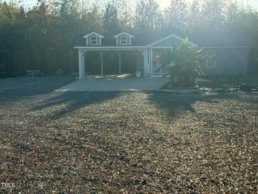 Gray house with carport and spacious yard at 31 Strickland Rd, Smithfield, NC 27577