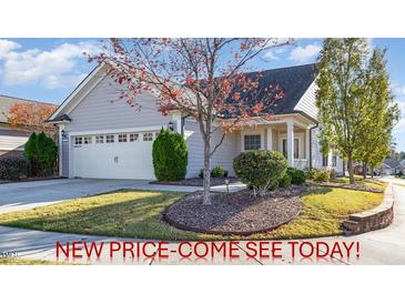 Charming home featuring a two-car garage, manicured landscaping, and mature trees in a desirable neighborhood at 219 Rosedale Creek Dr, Durham, NC 27703