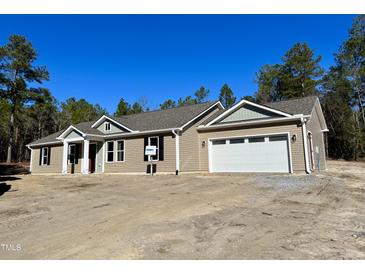 Newly constructed home with attached garage and ample yard space at 6648 Sheriff Watson Rd, Sanford, NC 27332