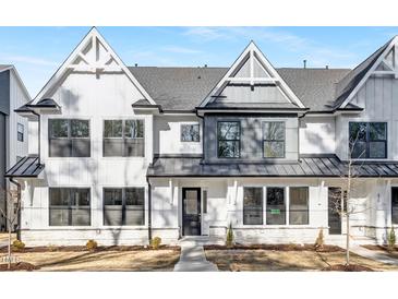 Charming new construction home featuring a modern design, black trim windows, and manicured landscaping at 324 Church St, Morrisville, NC 27560