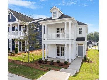 Inviting two-story home with a charming double porch and well-maintained landscaping at 716 Georgias Landing Pkwy # 12, Raleigh, NC 27603