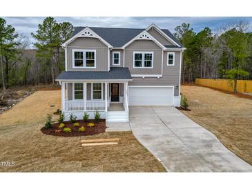 Charming two-story home with a welcoming front porch and attached two-car garage at 320 Duncan Creek Rd # 161, Lillington, NC 27546