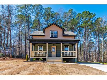 Charming two-story home features a welcoming front porch and beautifully landscaped front yard at 109 Lone Star Dr, Louisburg, NC 27549