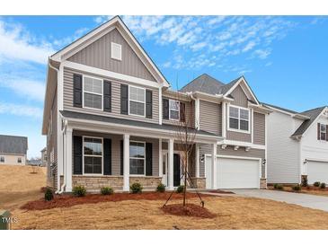 Beautiful two-story home with gray siding, stone accents, and a welcoming front porch at 347 N. Maple Walk Dr # 211, Garner, NC 27529