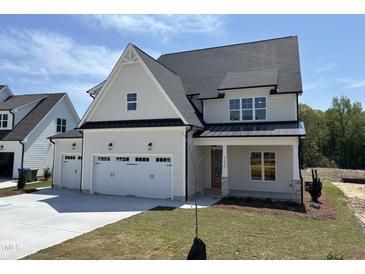 Beautiful two-story home featuring a three-car garage and a welcoming front porch at 3520 Amelia Grace Dr # 30, Fuquay Varina, NC 27526