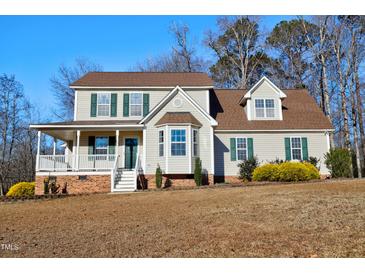 Two-story house with a large front porch, double garage, and landscaped yard at 430 Carrington Dr, Garner, NC 27529