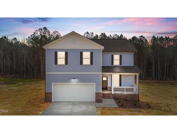 Charming two-story home with blue siding, white trim, and an attached two-car garage at 9133 Phoenix Ct, Middlesex, NC 27557