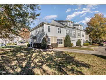 Charming multi-story townhome with a landscaped front yard, sidewalk, and driveway, perfect for comfortable suburban living at 526 Elm Ave, Wake Forest, NC 27587