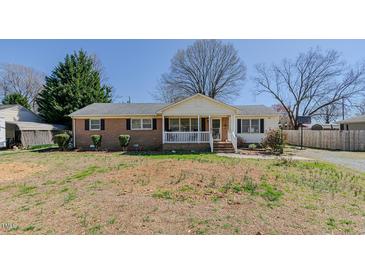 Charming single-story home with brick and vinyl siding, a cozy front porch, and a spacious front yard at 2434 Orice St, Burlington, NC 27215