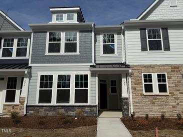 New townhome exterior showing stone accents, painted siding, and large picture windows at 424 La Maison Ave # 9, Wendell, NC 27591