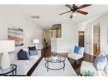 Inviting living room features neutral tones, plush seating, and a cozy ambiance at 8204 Yaxley Hall Dr, Raleigh, NC 27616