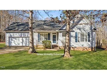 Gray house with a two-car garage and landscaped lawn at 85 Applecross Dr, Franklinton, NC 27525