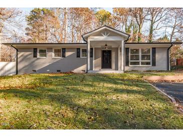 Charming single-story home with a modern painted brick exterior and manicured front lawn at 6512 Johnsdale Rd, Raleigh, NC 27615