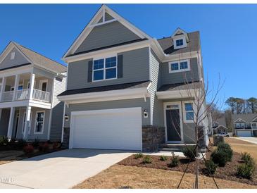 Charming two-story home featuring a 2-car garage and welcoming front yard at 8 Steppe Way, Garner, NC 27529