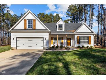 Two-story house with white siding, brown shutters, and a two-car garage at 151 Ottawa Dr, Louisburg, NC 27549