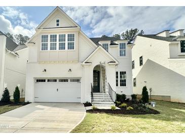 Charming two-story home with painted brick, a two-car garage, and well-maintained landscaping at 1721 Burnette Garden Path, Raleigh, NC 27612