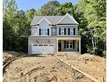 Charming two-story home featuring a gray exterior, black shutters, and an attached two-car garage at 2624 Silver Gate Ct, Wake Forest, NC 27587