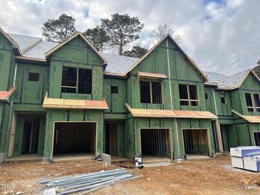 Brand new townhouses under construction, featuring contemporary design and attached garages at 4043 Elk Creek Ln # 15, Raleigh, NC 27612