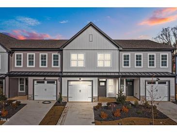 Attractive newly built townhomes boast neutral siding, matching garages and professionally landscaped yards at 707 Jamescroft Way, Rolesville, NC 27587
